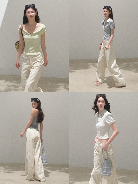 Fashion model wearing a pastel top with cream wide-leg pants and a silver handbag