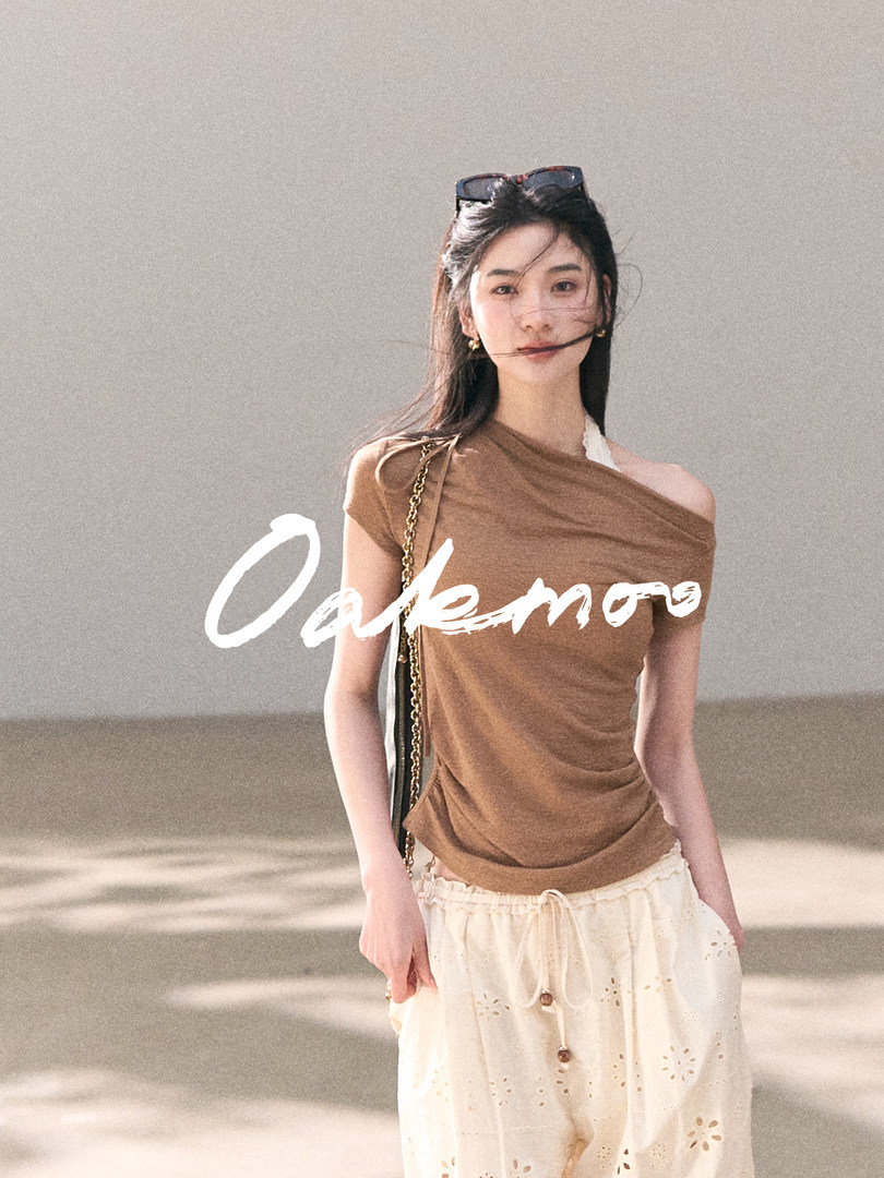 Model wearing a brown off-shoulder top with cream wide-leg pants