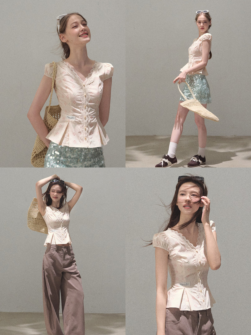 Model wearing a light pink feminine blouse with a teal skirt and straw bag
