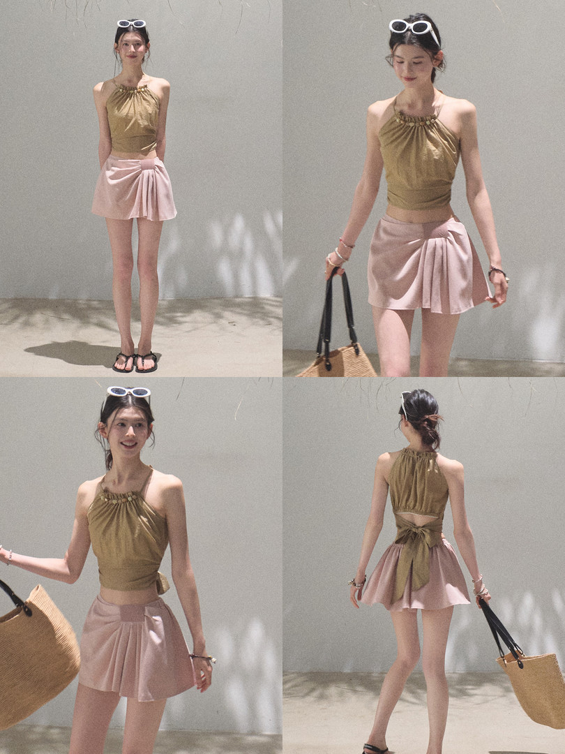 Model wearing a halter top with a pink wrap mini skirt set