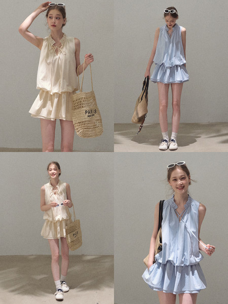 Models wearing sleeveless summer outfits with matching skirts and tote bags