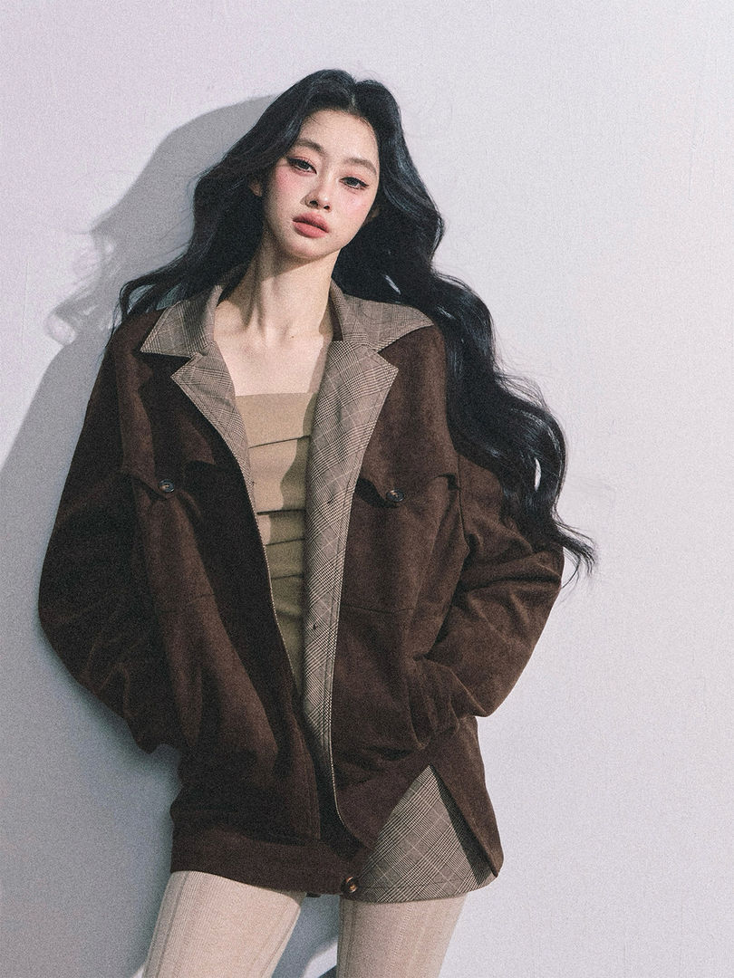Model wearing a brown plaid-trim blazer jacket