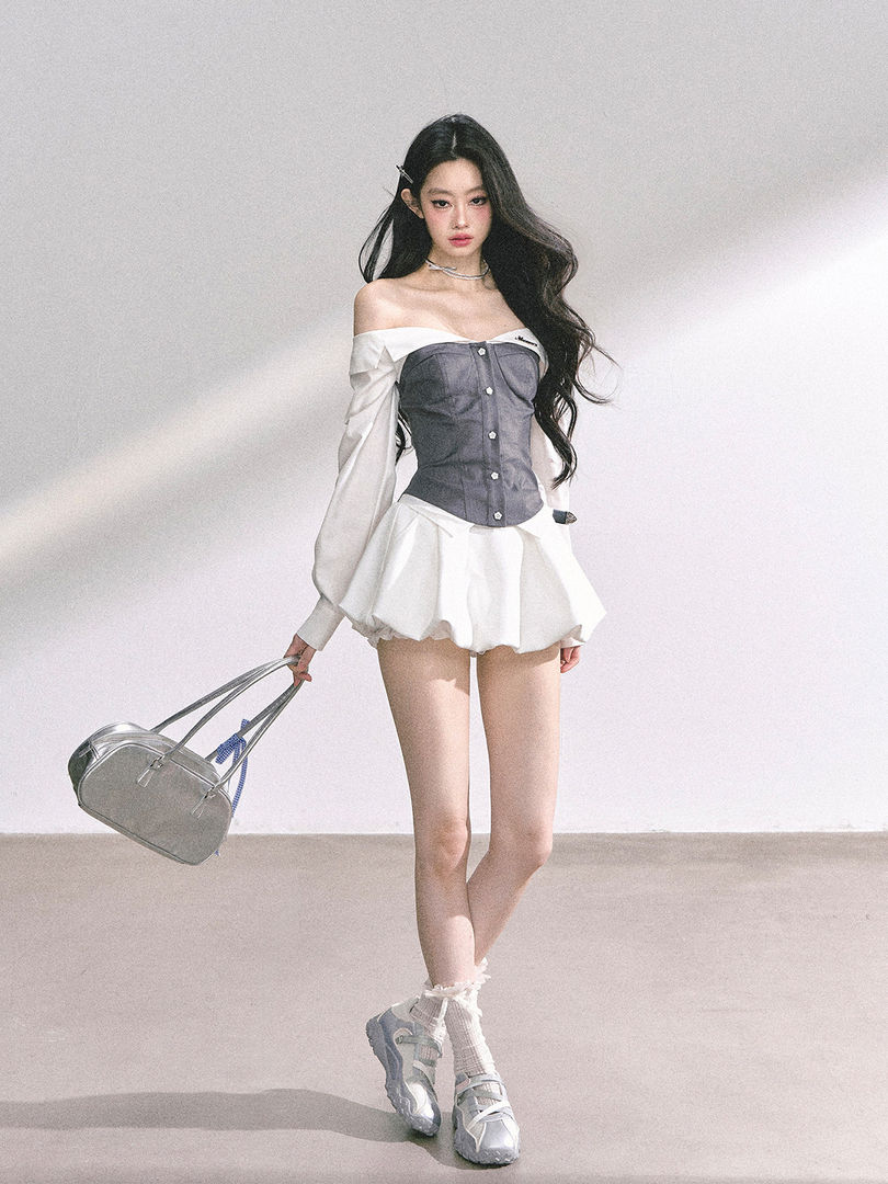 Model wearing a gray-and-white off-shoulder dress with a flared skirt