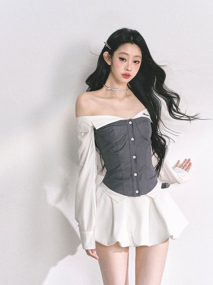 Model wearing a gray and white off-shoulder fashion outfit with a flared skirt