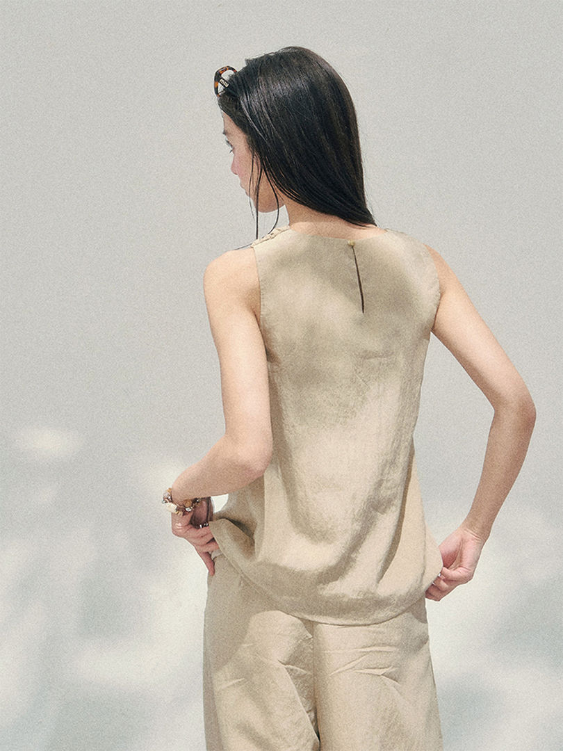 Beige sleeveless matching top and pants worn by a model