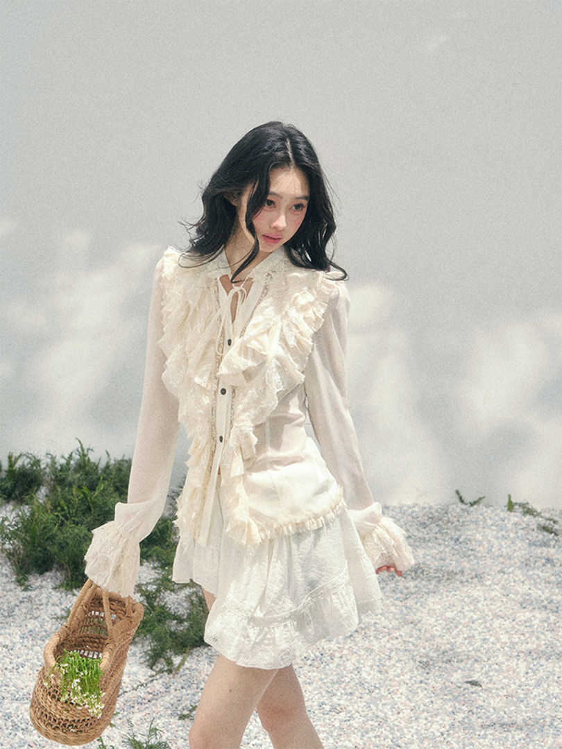 Woman wearing a white ruffled blouse and skirt outfit outdoors