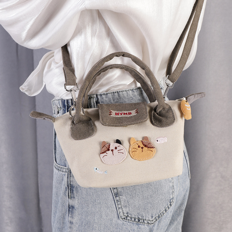 斜挎包手拎新款小众设计帆布女饺子包帆布包女包休闲手提小布包