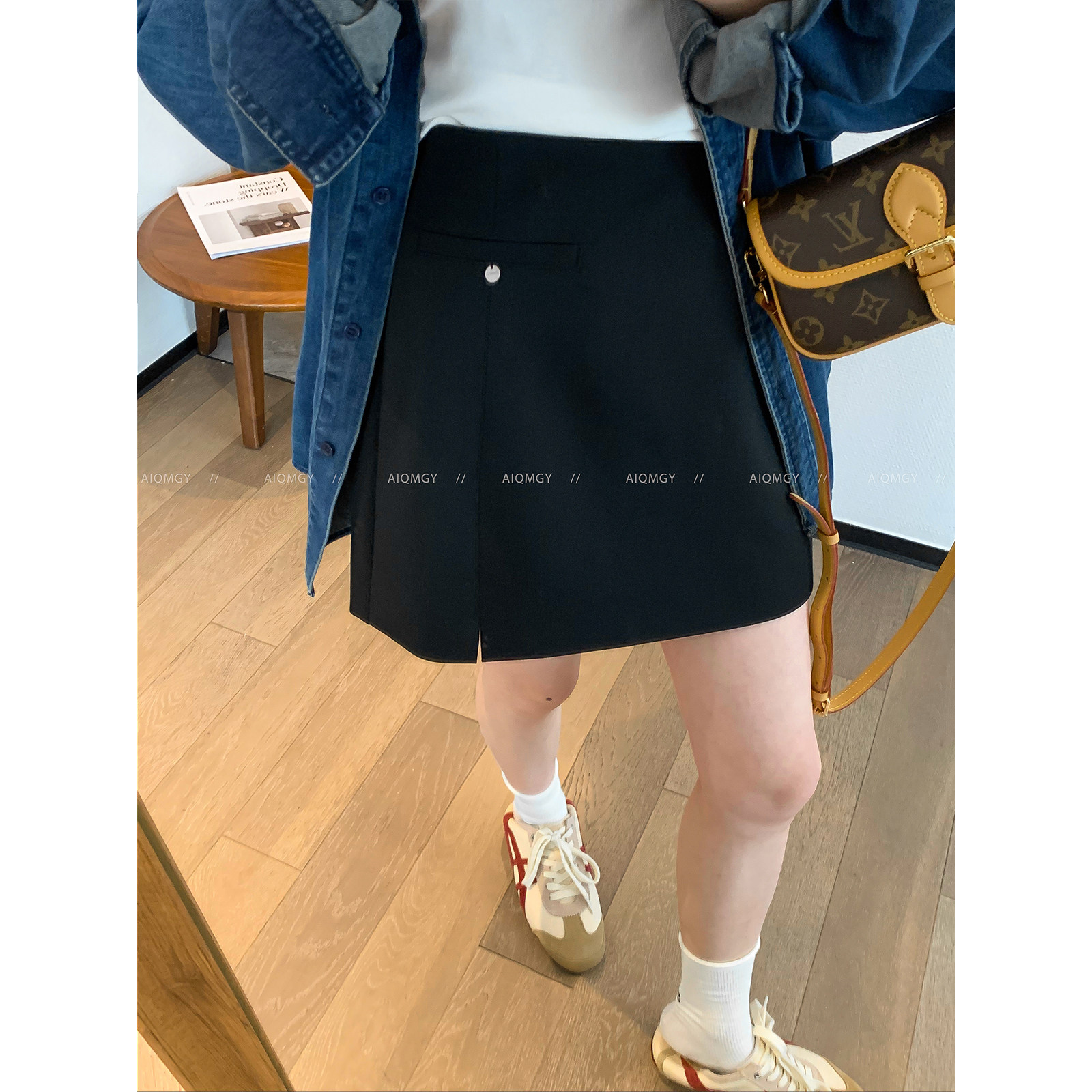 爱情魔鬼鱼 黑色高端通勤半身裙女2026春季新款高腰百搭A字短裙子