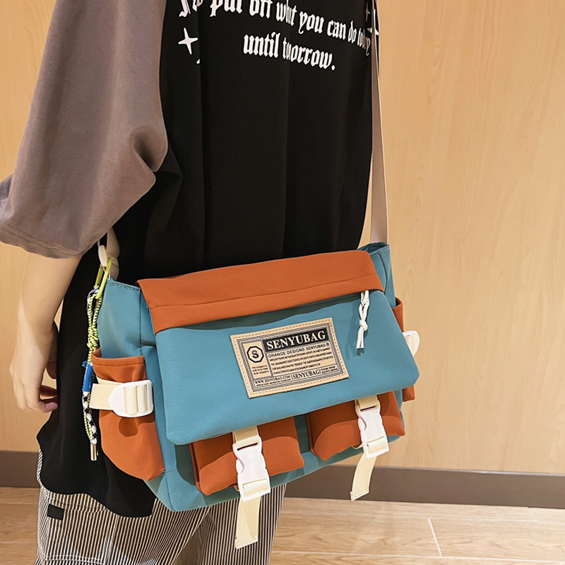 斜挎包男士休闲撞色大容量日系邮差包男生背包运动单肩包女帆布包