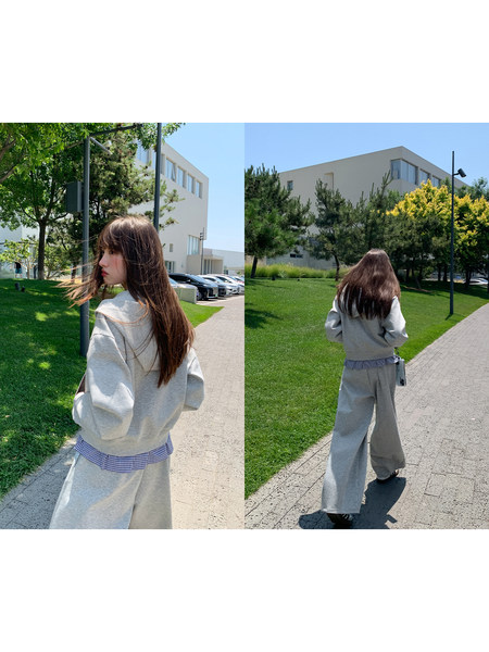 Model wearing a gray casual sweatshirt and wide-leg pants outdoors