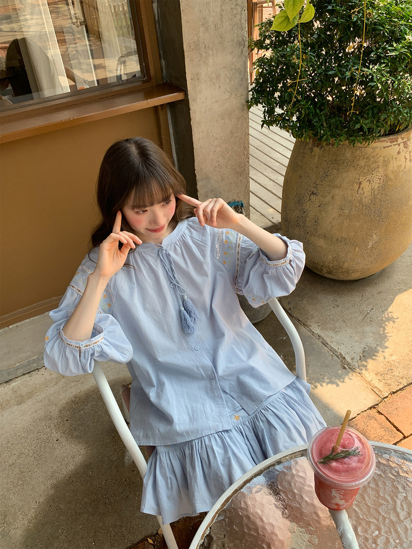 Light blue two-piece outfit worn by a model outdoors