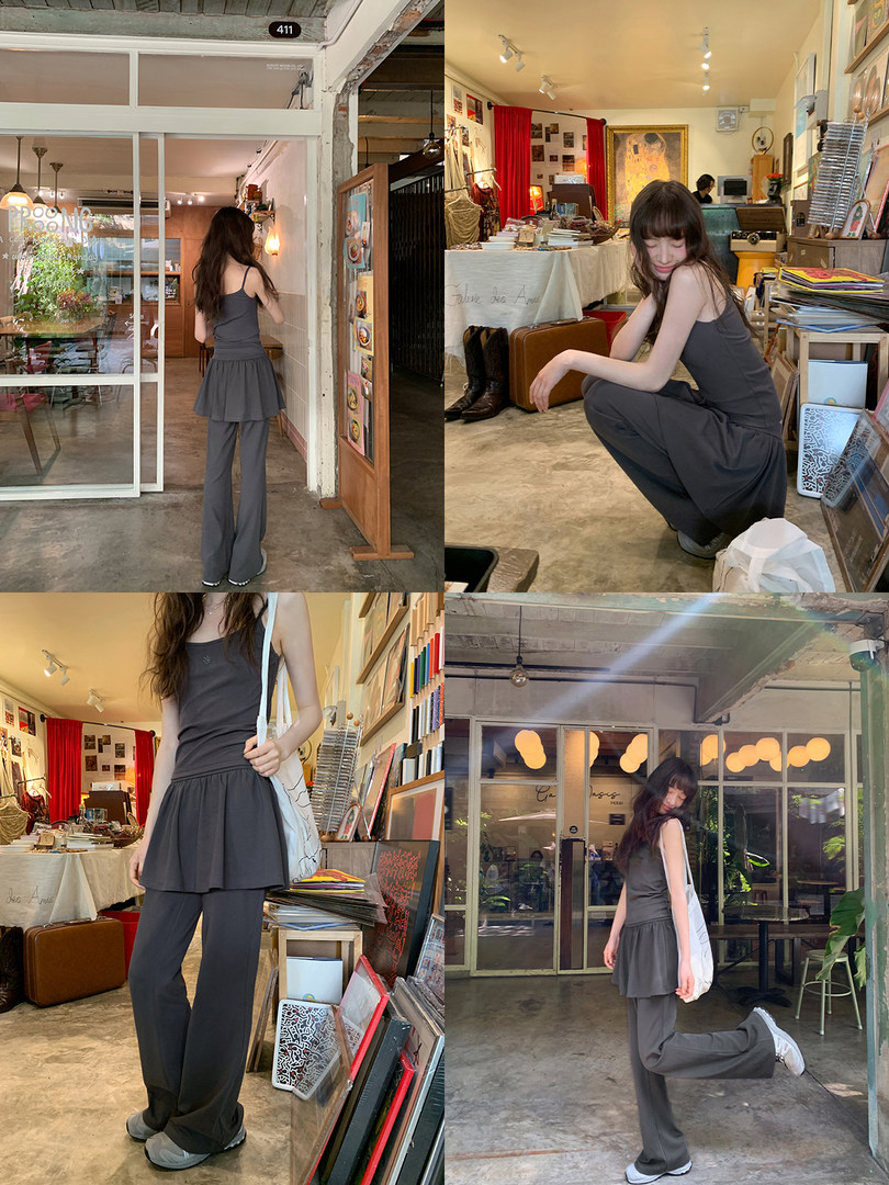 Gray sleeveless top and wide-leg pants outfit worn by a model in a casual indoor setting