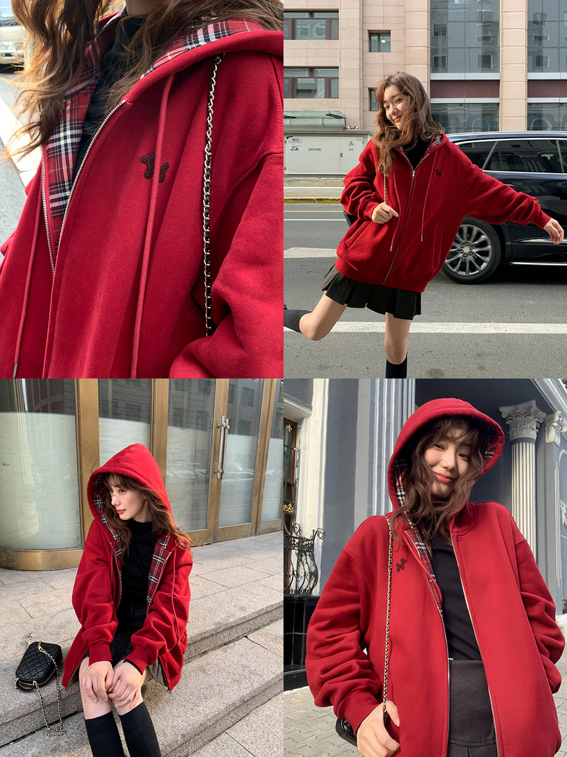 Red oversized hooded zip-up jacket worn by a model outdoors