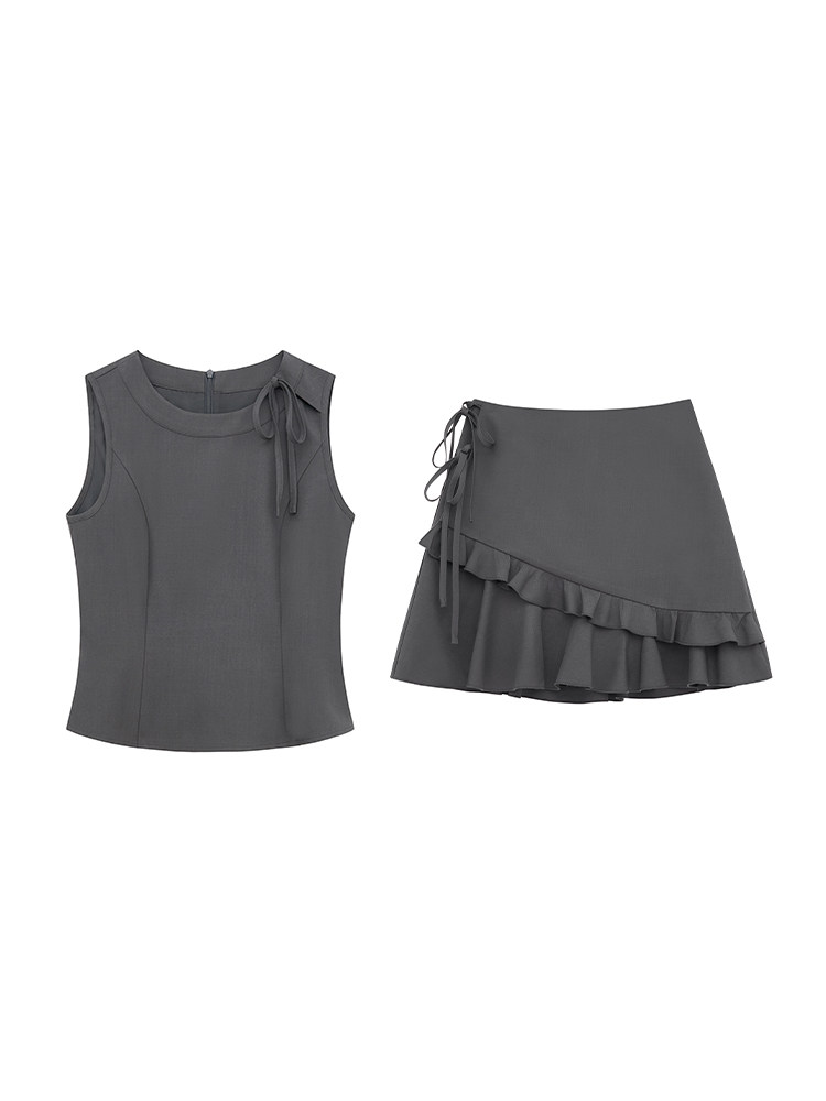 Dark gray sleeveless top and matching ruffled mini skirt set on a white background