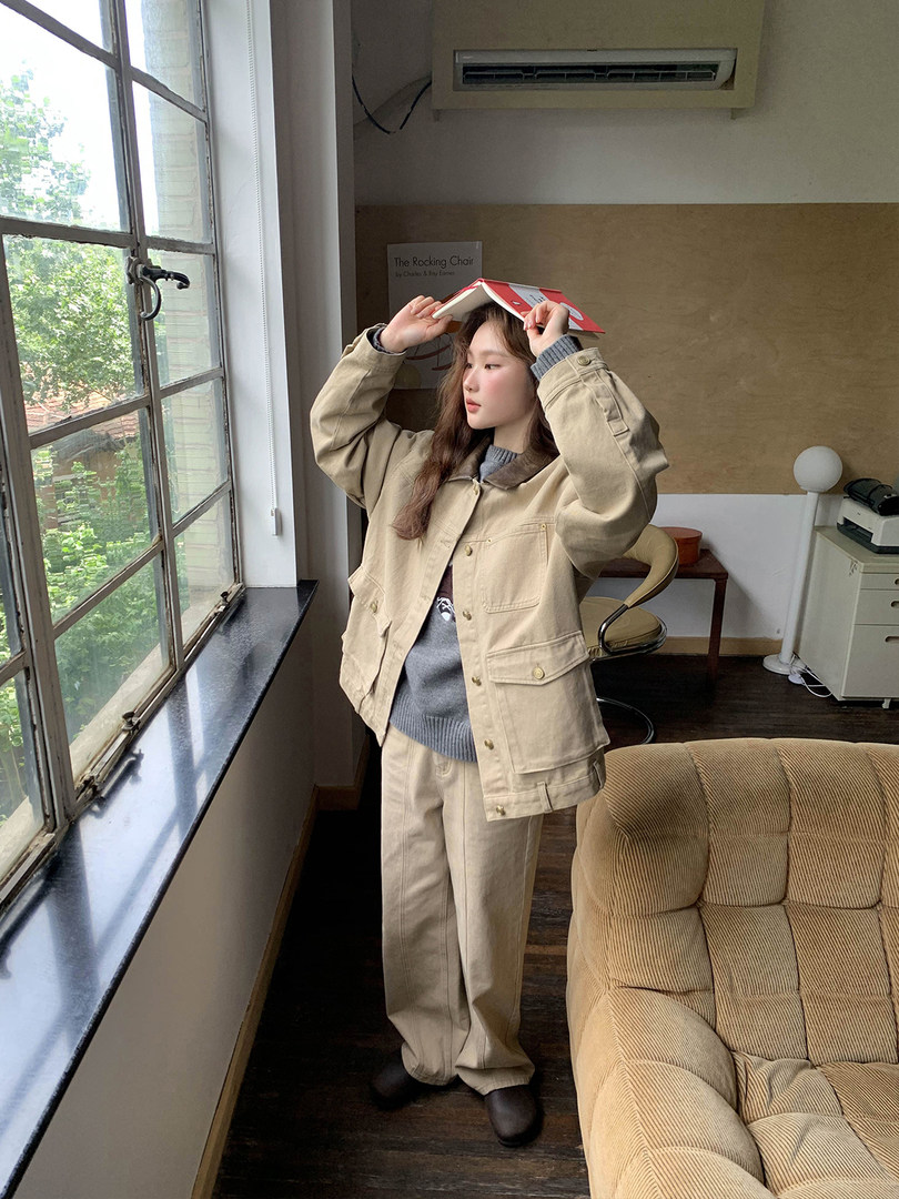 Beige jacket and matching pants outfit worn by a model indoors