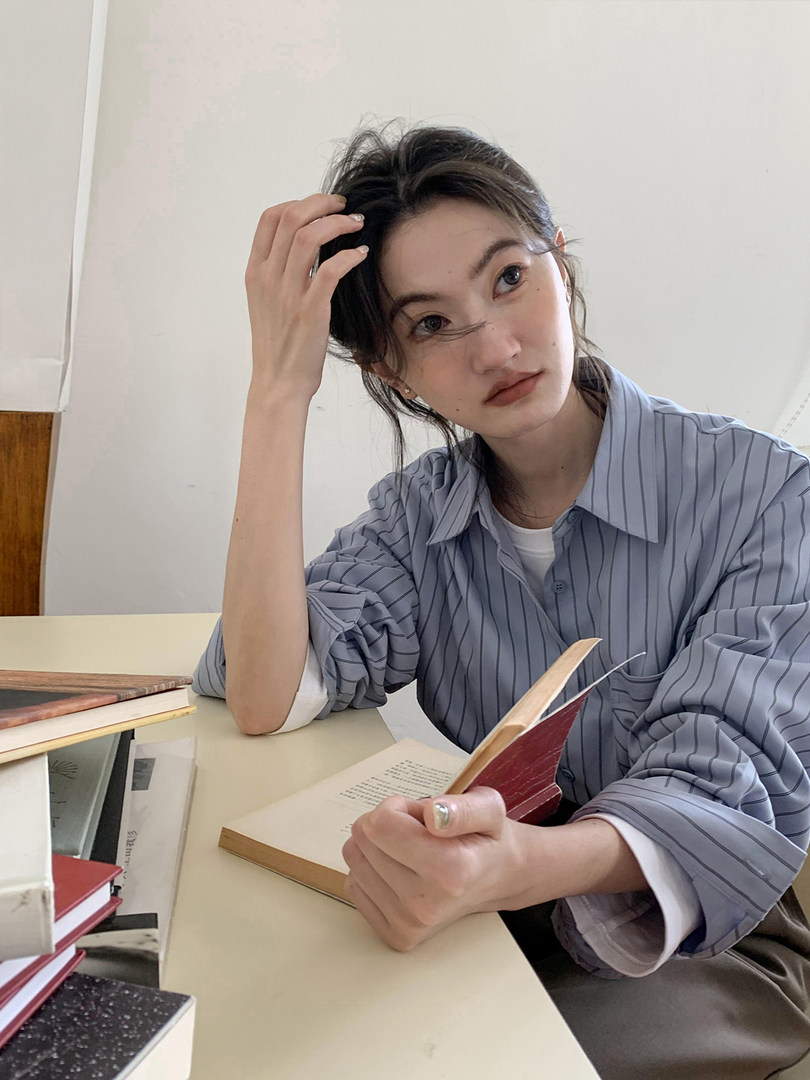 Woman wearing a blue striped button-up shirt
