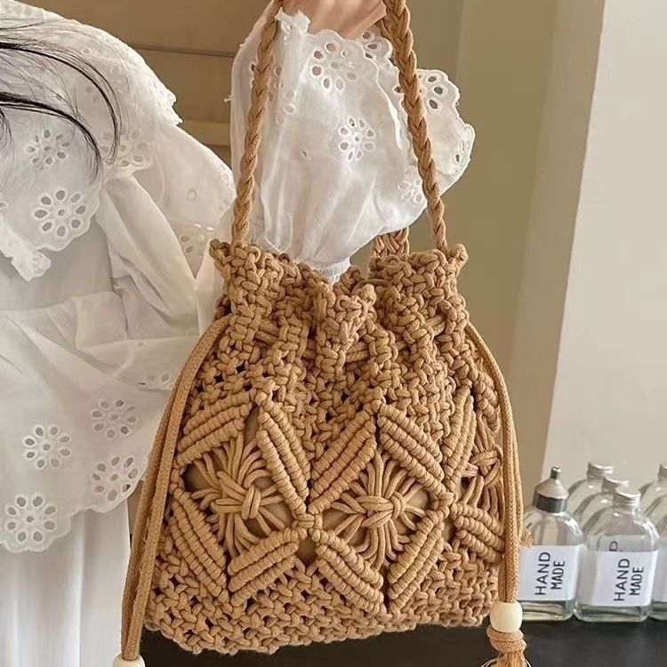 编织包包2026新款度假时尚斜挎包单肩水桶海边手工沙滩镂空编织包