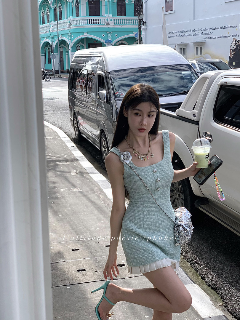Woman wearing a light blue textured mini dress outdoors