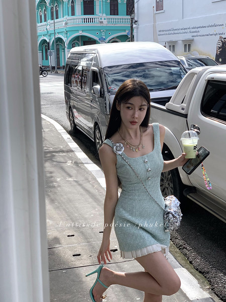 Woman wearing a light blue textured mini dress outdoors