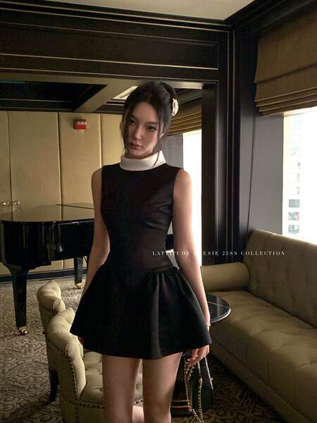 Black sleeveless mini dress worn by a model