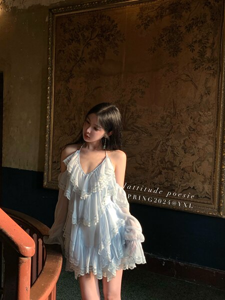 Model wearing a light blue ruffled lace dress