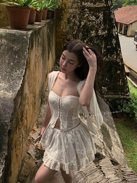 Woman wearing a white lace corset dress outdoors