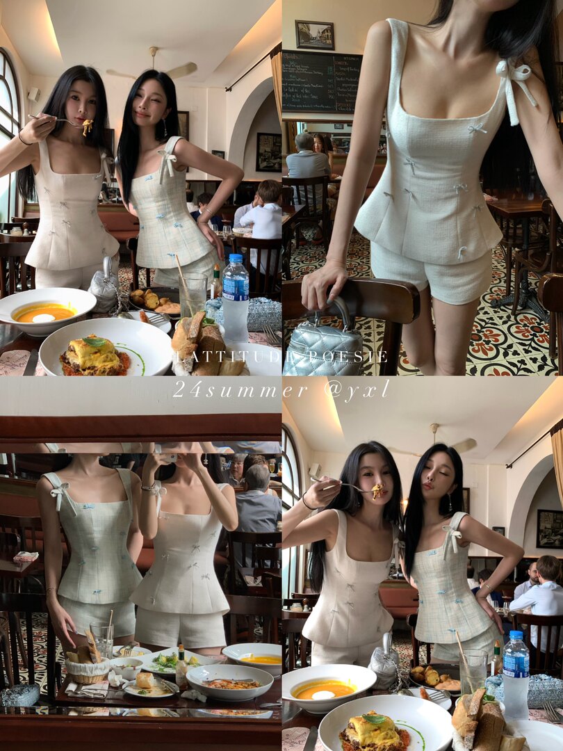 Two women wearing matching cream and mint summer two-piece outfits in a restaurant