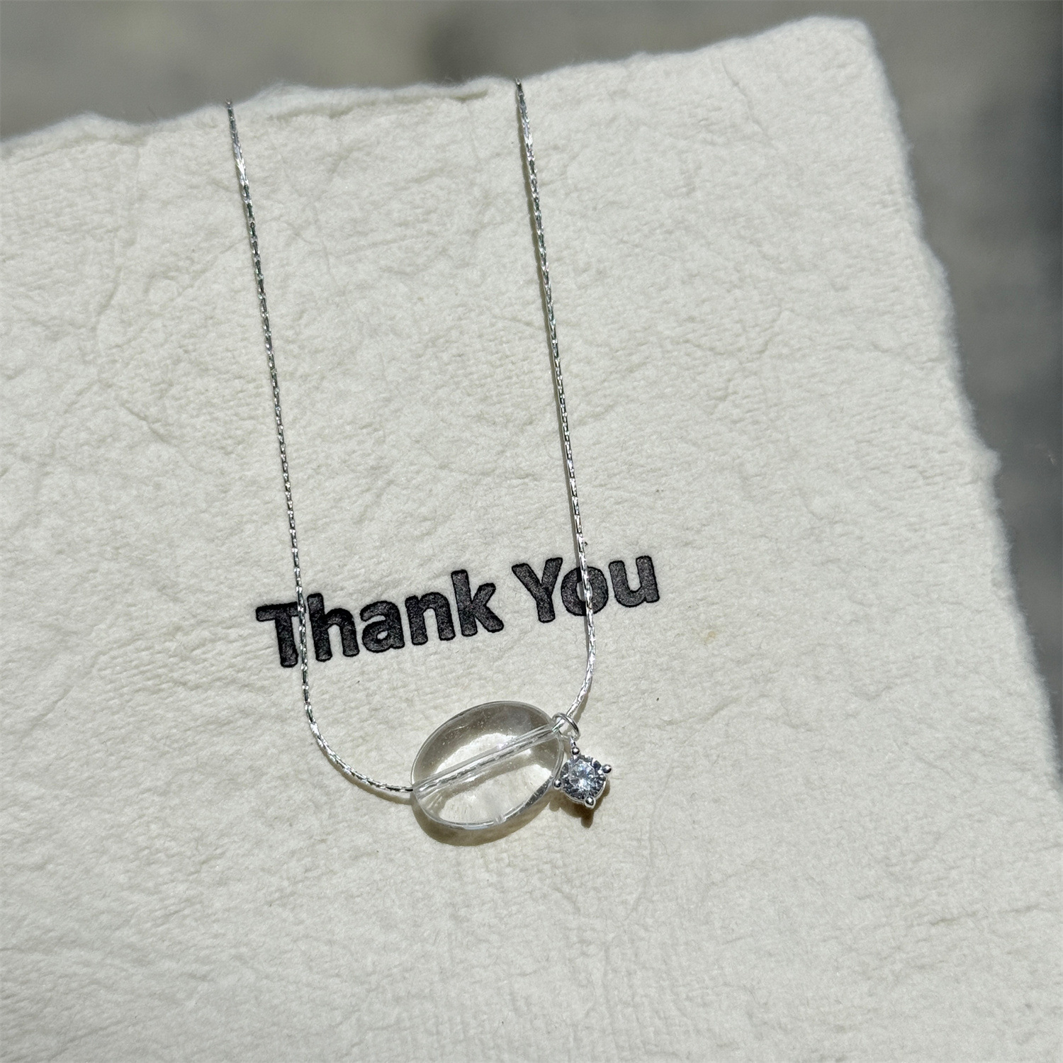 s925纯银四爪吊坠天然椭圆形白水晶项链女简约小众设计高级蛇骨链