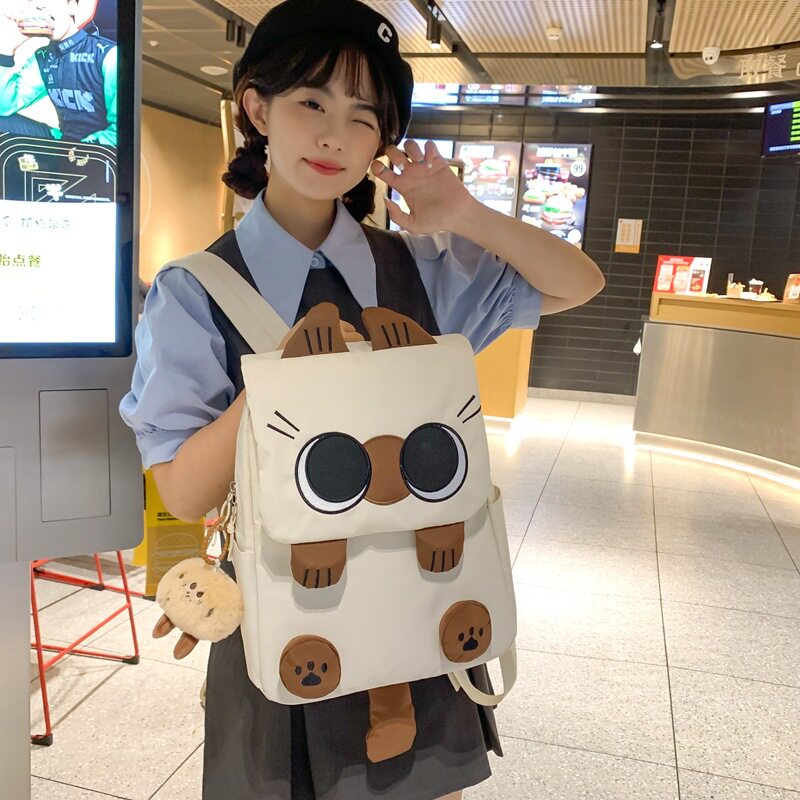 韩版新款书包轻便大容量小学生三到六年级学生双肩包丑萌猫咪背包