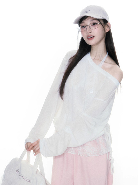 Model wearing a white off-shoulder long-sleeve top with pink pants and a light cap