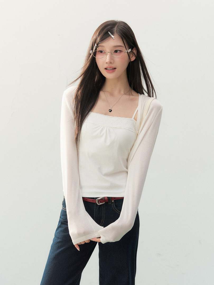 Model wearing a cream long-sleeve top with jeans