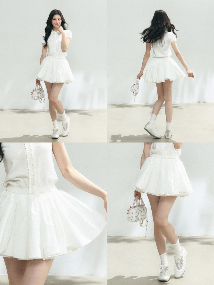White short-sleeve top and pleated mini skirt worn by a model