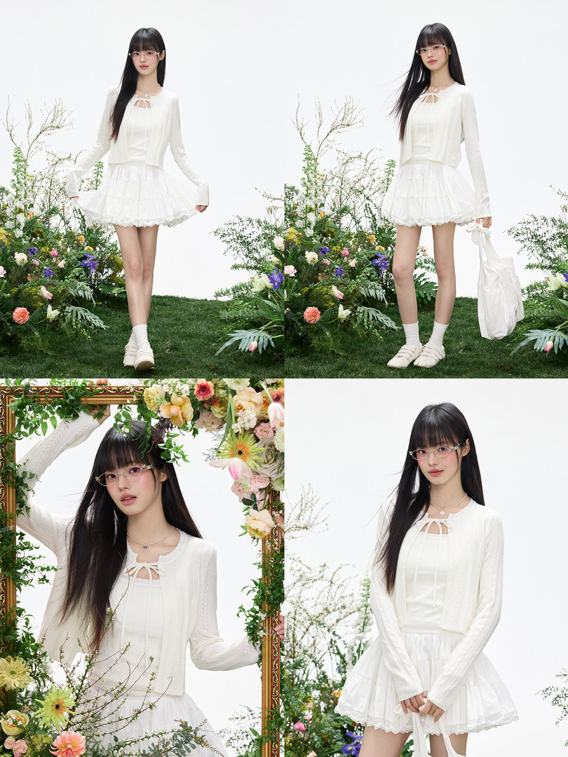 White feminine two-piece outfit worn by a model in a studio setting