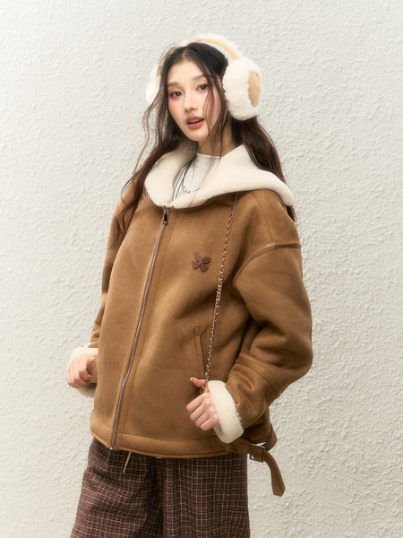 Woman wearing a brown shearling-lined hooded jacket with earmuffs