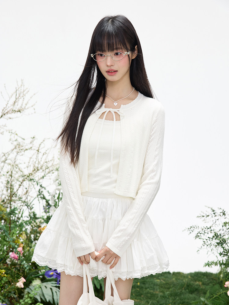 Woman wearing a white lightweight cardigan and skirt set