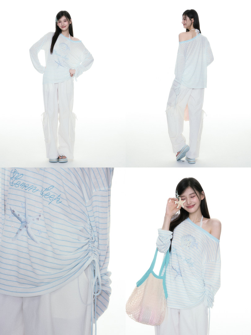 Model wearing a light blue striped off-shoulder top and loose white pants set