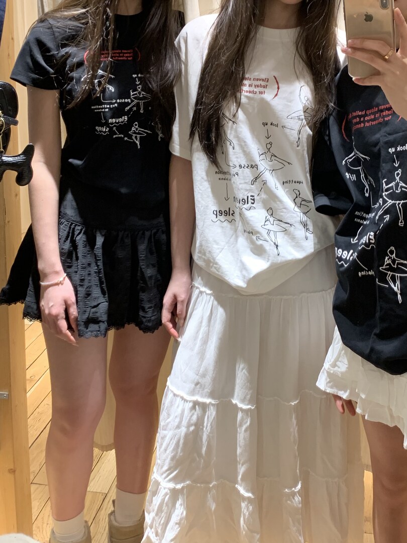Women wearing graphic print T-shirts with tiered skirts in black and white