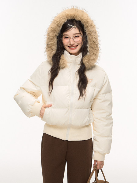 Model wearing a cream puffer jacket with fur-trimmed hood