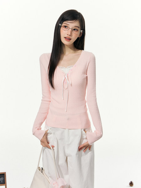 Model wearing a light pink ribbed long-sleeve lace-trim top