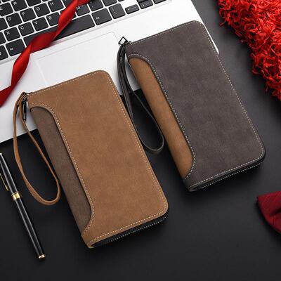 A mans long wallet with a bag and a sandy multi-purpose mob