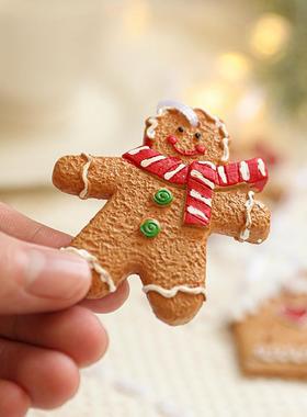 The gingerbread man hangs out with a gingerbread house with