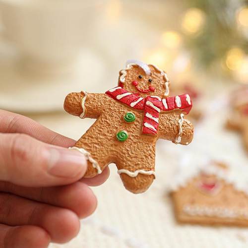 The gingerbread man hangs out with a gingerbread house with