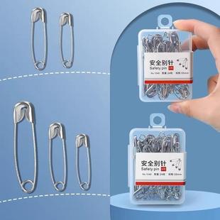 Old-style safety pins, clothing pins, small and large paper
