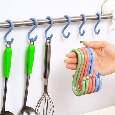 S-shaped hooks behind the door for small items in clothing s