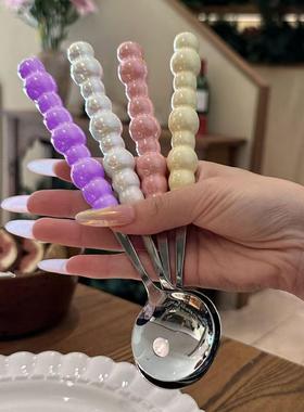 Stainless steel pearl handle spoon, ideal for home use as a