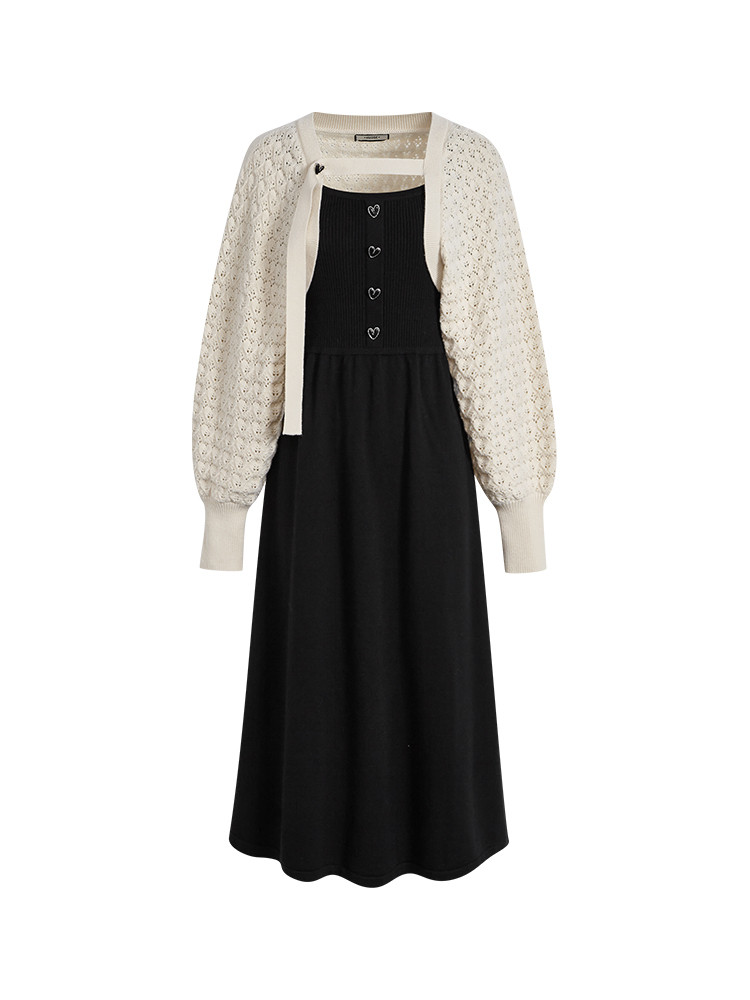 Black midi dress with cream cardigan on a white background