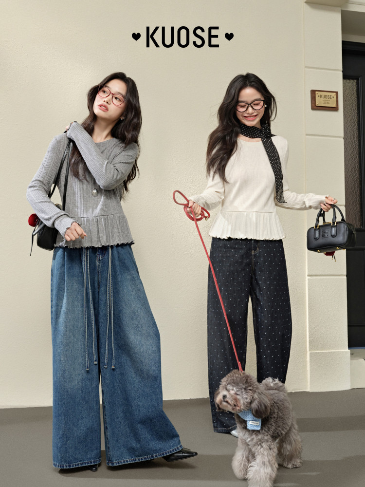 Two women modeling casual layered outfits with long-sleeve tops and wide-leg pants, each carrying a handbag