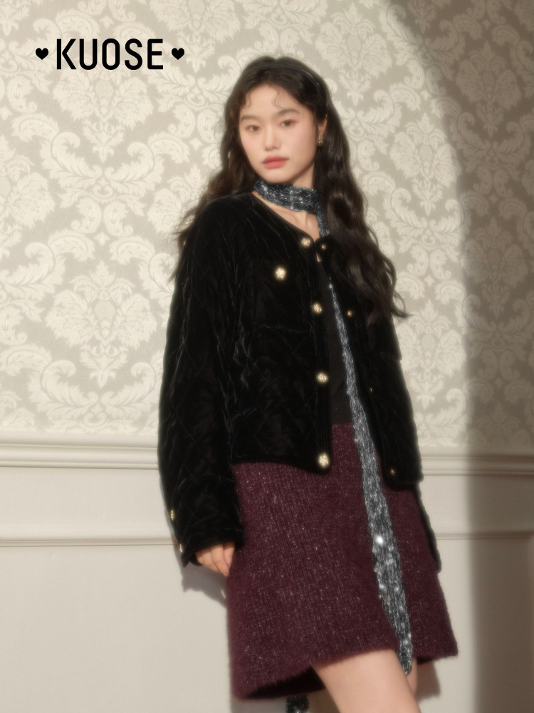 Model wearing a black velvet jacket with a maroon skirt and silver scarf