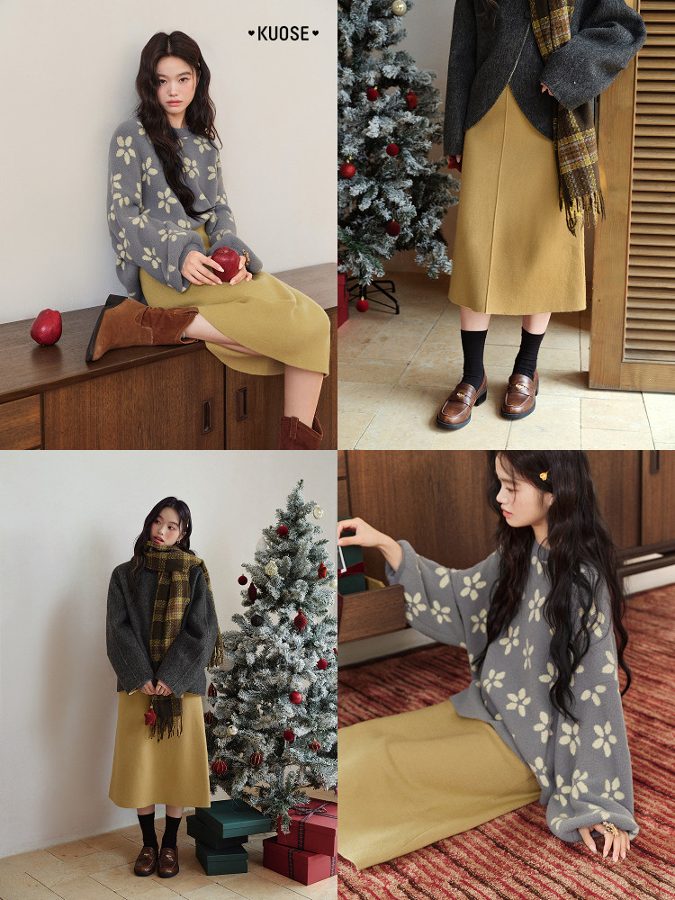 Model wearing a gray floral sweater with a mustard midi skirt and scarf in a winter holiday setting