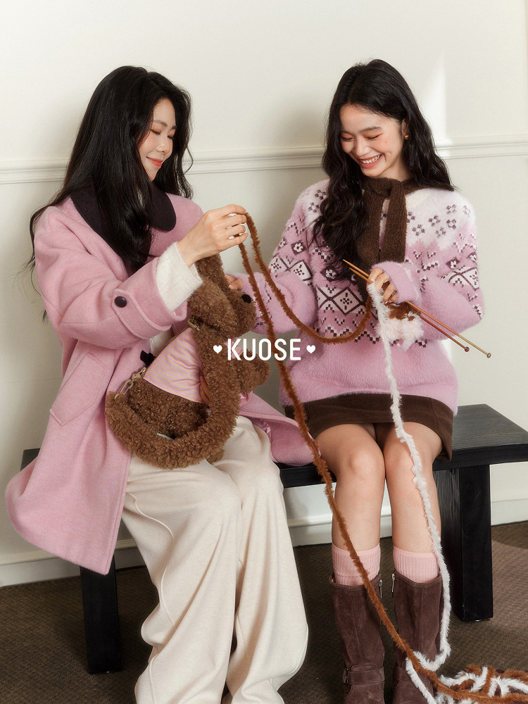 Two women wearing pink knit winter outfits with brown accessories and boots